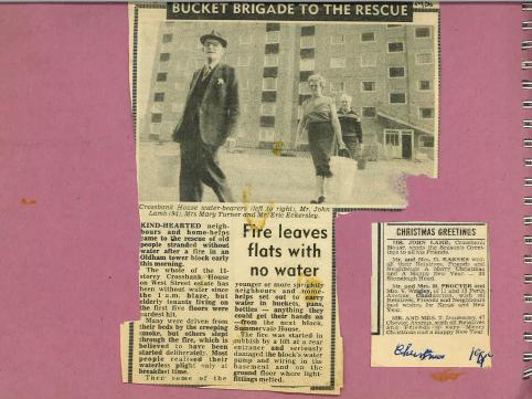A scan of a newspaper clipping with the headline “Bucket brigade to the rescue” and the subheading “Fire leaves flats with no water”. The article is accompanied by a photo of three residents carrying buckets of water from Summervale House to Crossbank House. The residents are Mr John Lamb, Mrs Mary Turner and Mr Eric Eckersley. There is another, smaller news clipping in the scan, of Mr John Lamb sending Christmas greetings to all his friends. The clippings are backed on pink card.